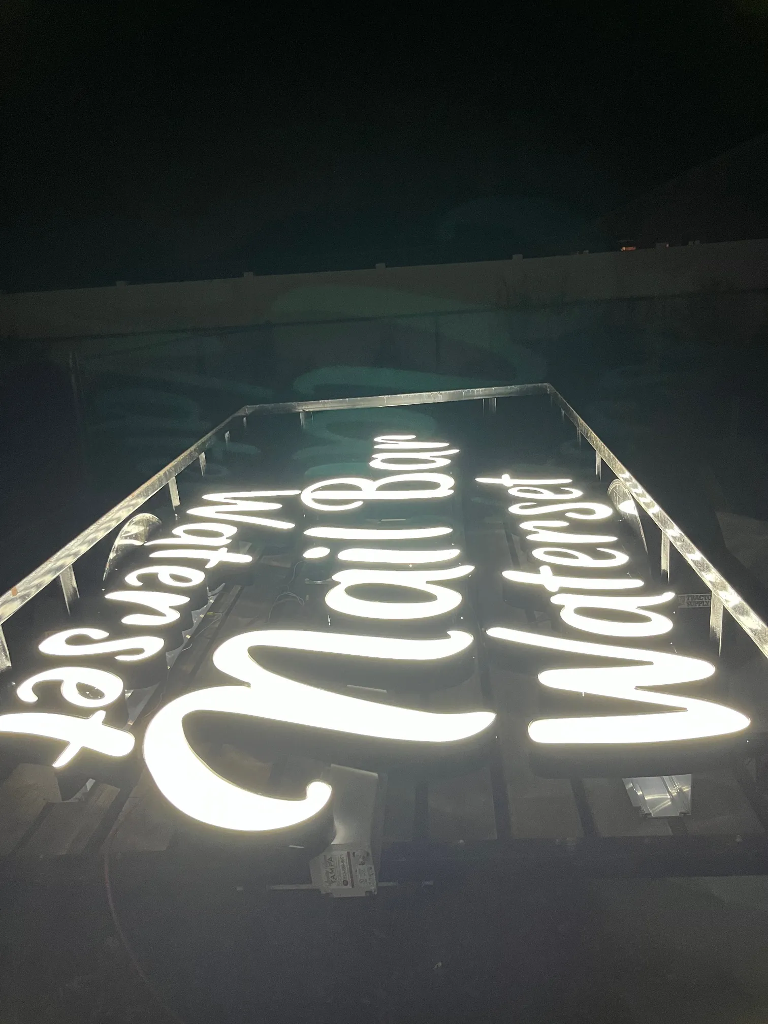 Lit script channel letters at night