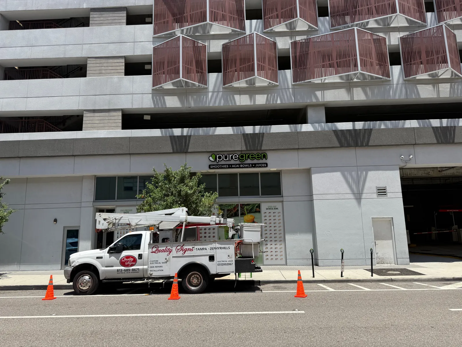 Quality Signs bucket truck installing storefront channel letters